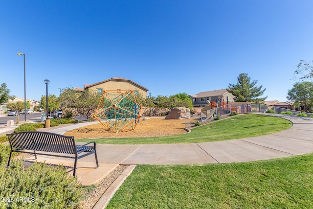 view of home's community with a yard and playground community