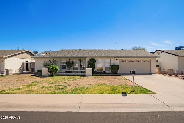 ranch-style house with fence, a garage, concrete driveway, a front lawn, and stucco siding