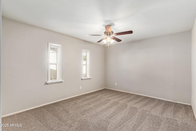 unfurnished room featuring baseboards, carpet floors, and ceiling fan