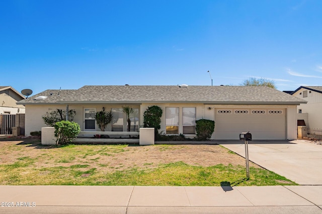 single story home with driveway, a garage, fence, and roof with shingles