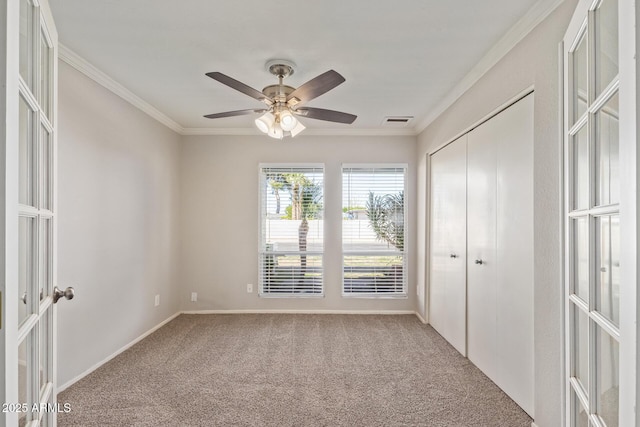 unfurnished bedroom with carpet flooring, ornamental molding, visible vents, and french doors