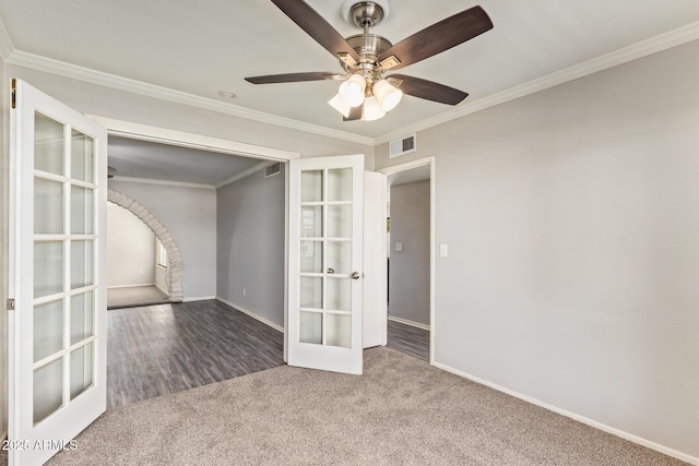 spare room with crown molding, carpet floors, french doors, baseboards, and visible vents