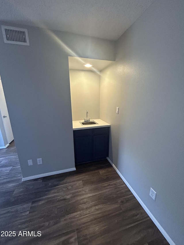 bathroom featuring wood-type flooring, a textured ceiling, and vanity