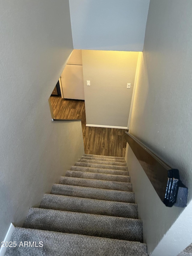 stairs with wood-type flooring