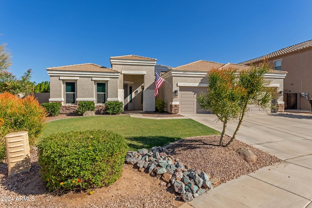 view of front of property featuring a front yard and a garage