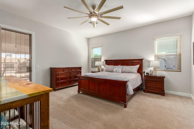 carpeted bedroom with access to outside, multiple windows, and ceiling fan