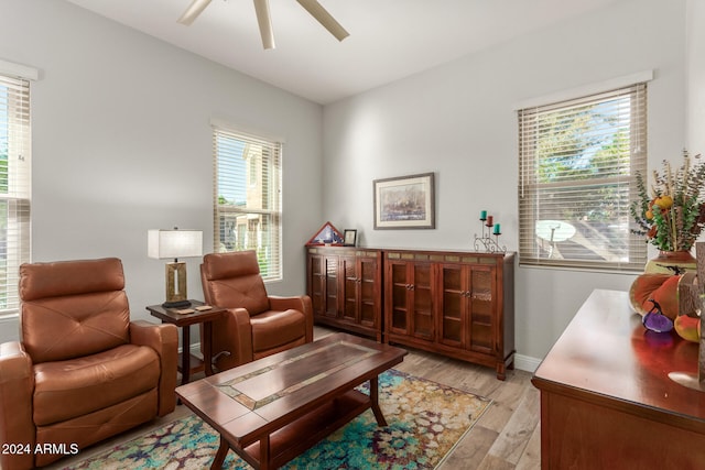 sitting room with light hardwood / wood-style floors and ceiling fan