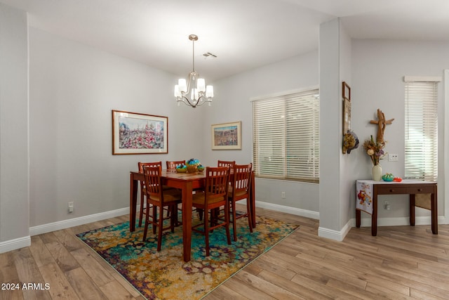 dining area with an inviting chandelier and light wood-type flooring