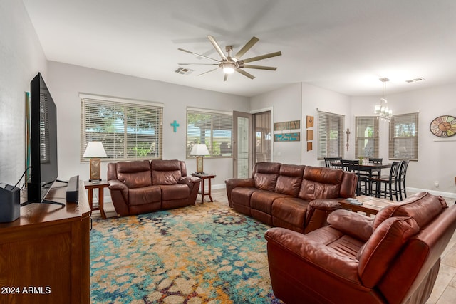 living room featuring light hardwood / wood-style flooring and ceiling fan with notable chandelier