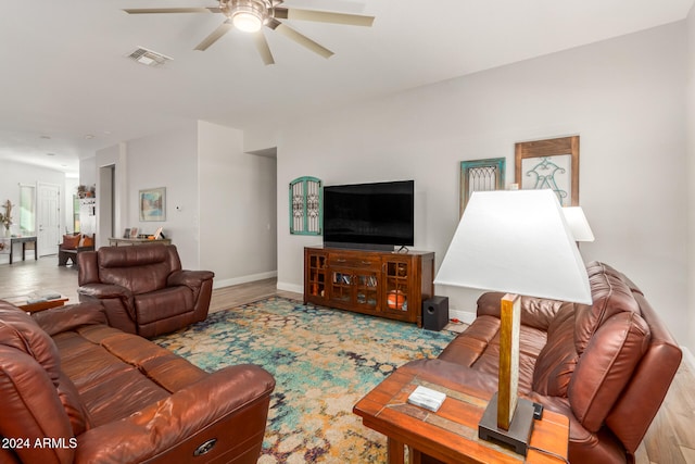 living room with light wood-type flooring and ceiling fan