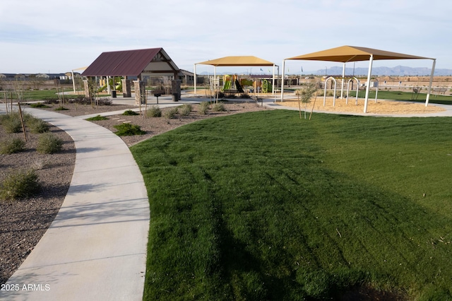 view of home's community featuring a gazebo, a yard, and playground community