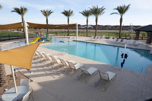 pool with a patio and fence
