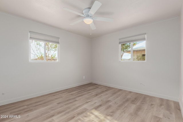 spare room with ceiling fan, light hardwood / wood-style floors, and crown molding