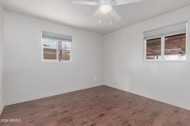 unfurnished room featuring ceiling fan and dark wood-type flooring