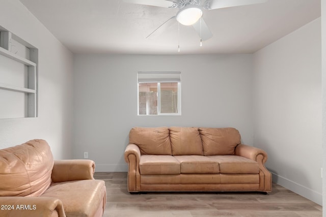 living room with light wood-type flooring and ceiling fan