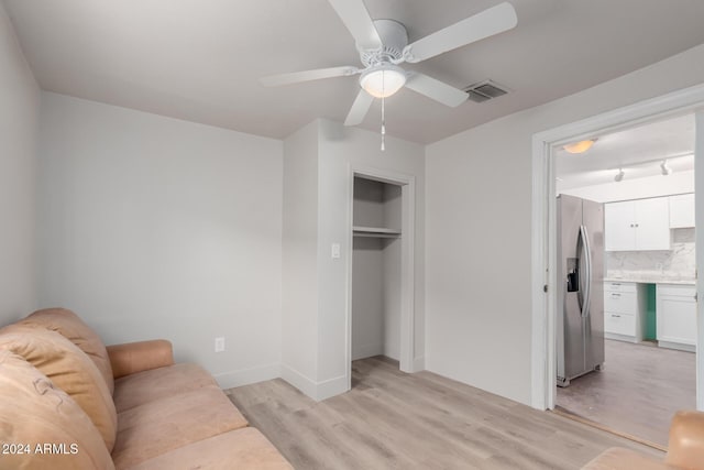 living room with ceiling fan and light hardwood / wood-style floors