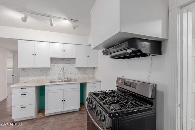 kitchen featuring white cabinets, stainless steel range with gas cooktop, sink, and light hardwood / wood-style flooring