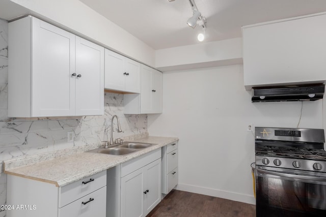 kitchen with gas range, sink, white cabinets, and extractor fan