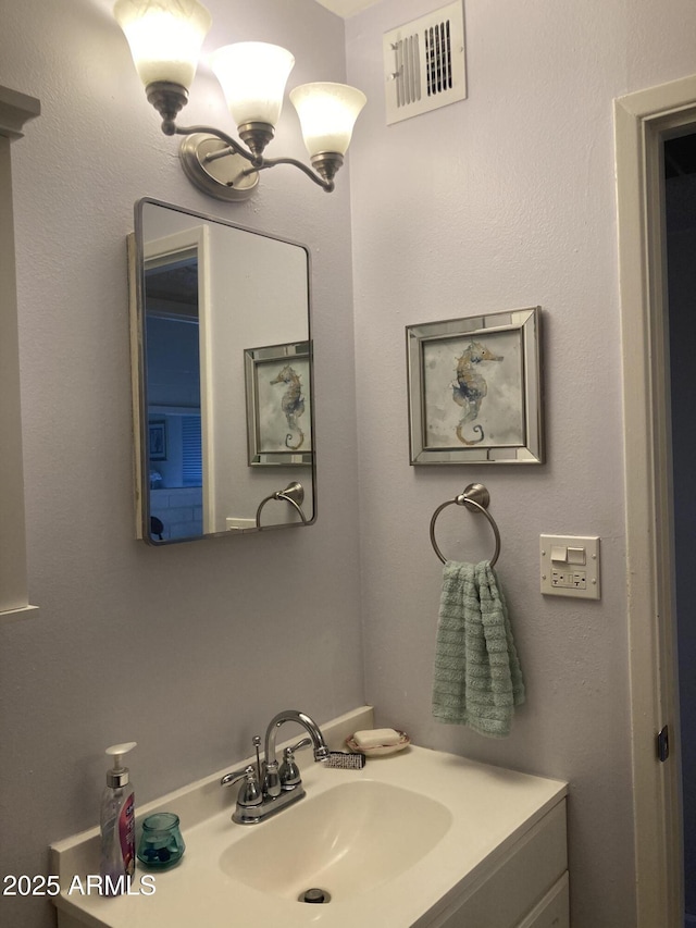 bathroom with visible vents and vanity
