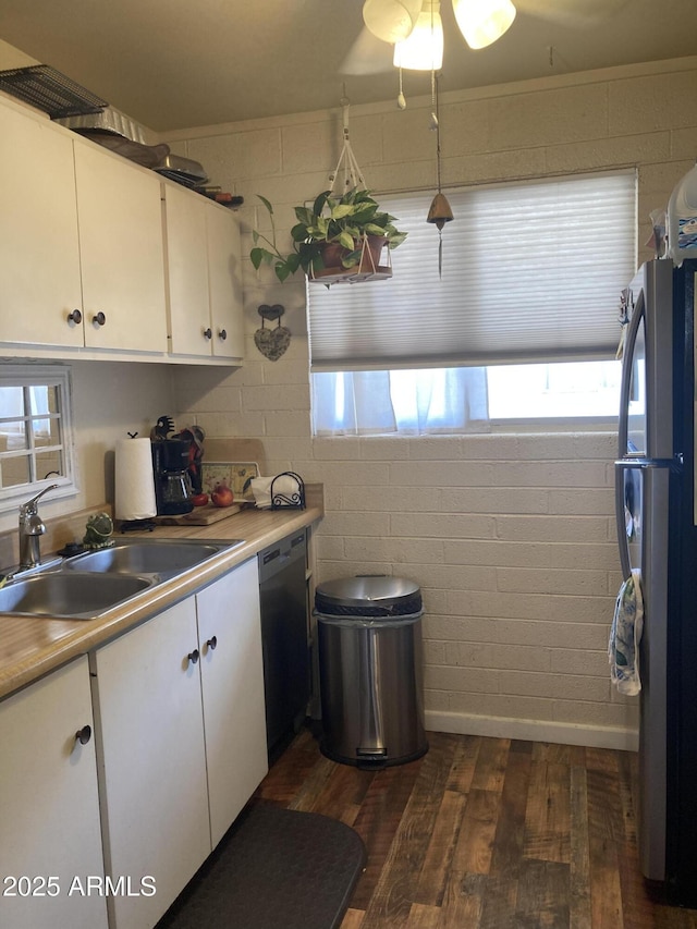 kitchen featuring a sink, white cabinets, freestanding refrigerator, and dishwasher