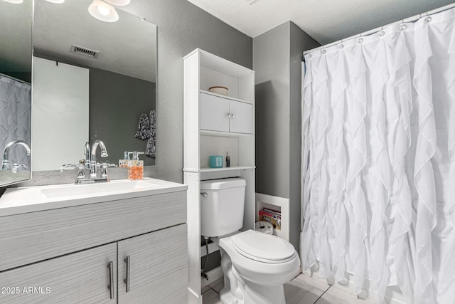 bathroom with visible vents, vanity, tile patterned floors, toilet, and a shower with shower curtain