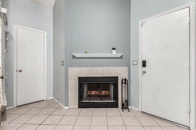 interior space featuring baseboards and a tile fireplace