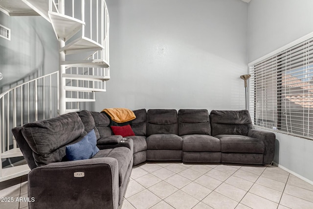 living area featuring light tile patterned flooring and visible vents