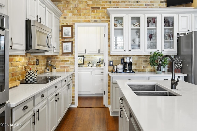 kitchen with stainless steel appliances, white cabinets, and a sink