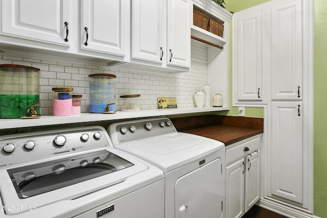 washroom with separate washer and dryer and cabinet space