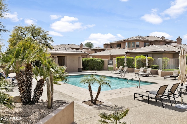 pool with fence and a patio