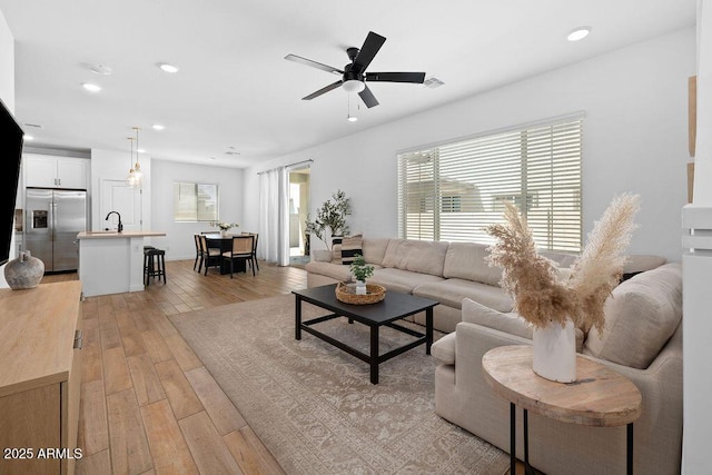9230 E Scott Ave, Mesa, AZ 85212 - living room with light wood-style floors, ceiling fan, and recessed lighting