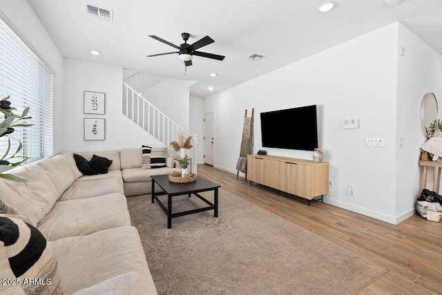9230 E Scott Ave, Mesa, AZ 85212 - living room featuring light wood-style flooring, stairway, baseboards, ceiling fan, and recessed lighting