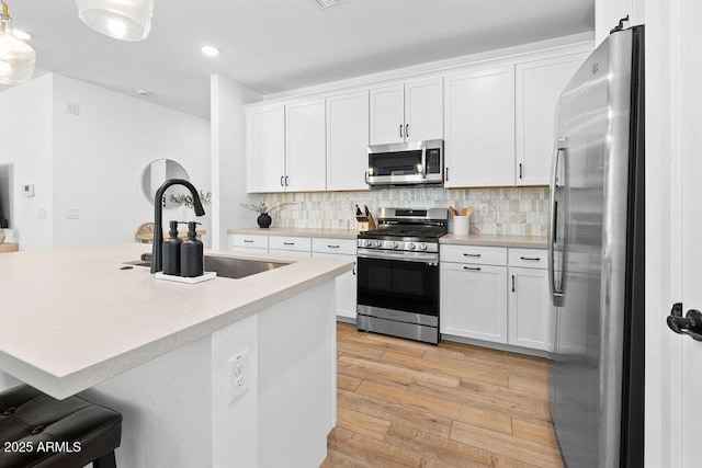 9230 E Scott Ave, Mesa, AZ 85212 - kitchen featuring appliances with stainless steel finishes, a sink, light wood-style floors, light countertops, and recessed lighting