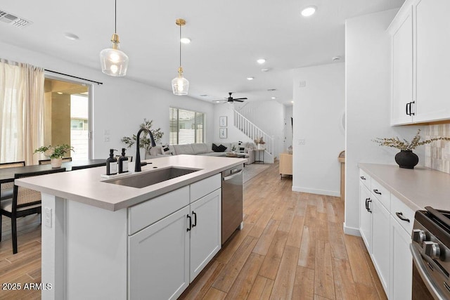 9230 E Scott Ave, Mesa, AZ 85212 - kitchen featuring a sink, light wood-style floors, stainless steel appliances, open floor plan, and light countertops