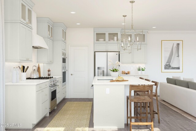 7987 W Griswold Rd, Peoria, AZ 85345 - kitchen with decorative backsplash, light wood-style flooring, a kitchen island, appliances with stainless steel finishes, and a kitchen breakfast bar