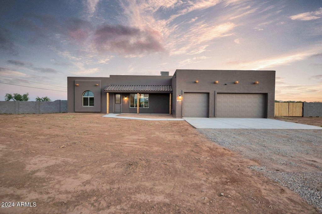 pueblo-style house with a garage