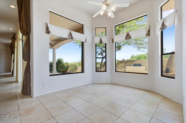 interior space featuring a high ceiling, light tile patterned floors, and a notable chandelier