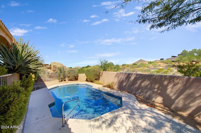 view of swimming pool with a mountain view