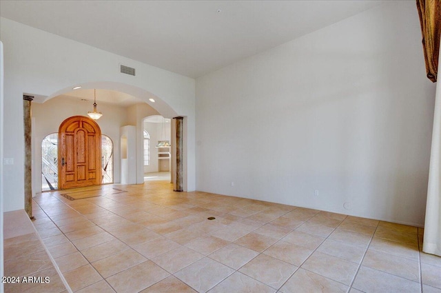 unfurnished living room featuring light tile patterned floors