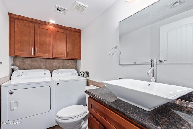 washroom with washer and clothes dryer and sink