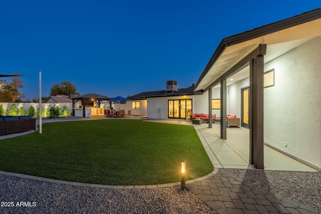 view of yard featuring an outdoor living space, french doors, and a patio area