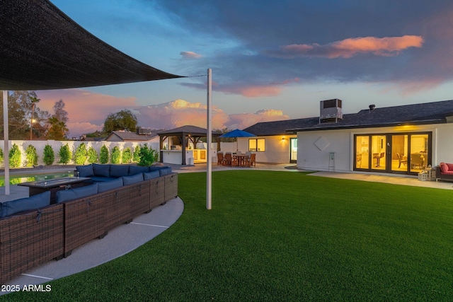 back of property with a lawn, a gazebo, a patio area, and outdoor lounge area