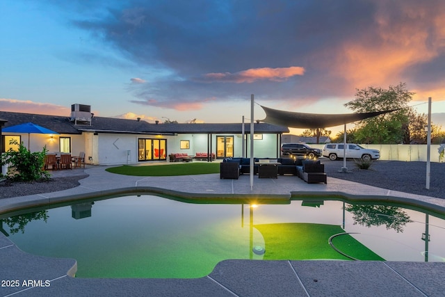view of swimming pool featuring a patio, an outdoor living space, fence private yard, and a fenced in pool