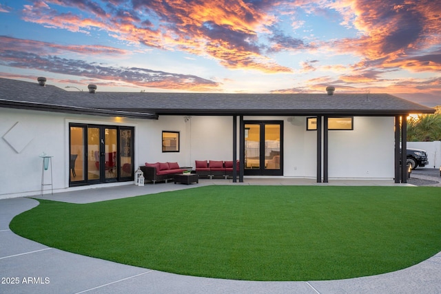 back of property featuring an outdoor hangout area, a patio, a shingled roof, and a yard
