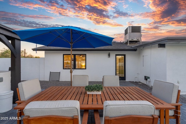 exterior space with outdoor dining space and stucco siding