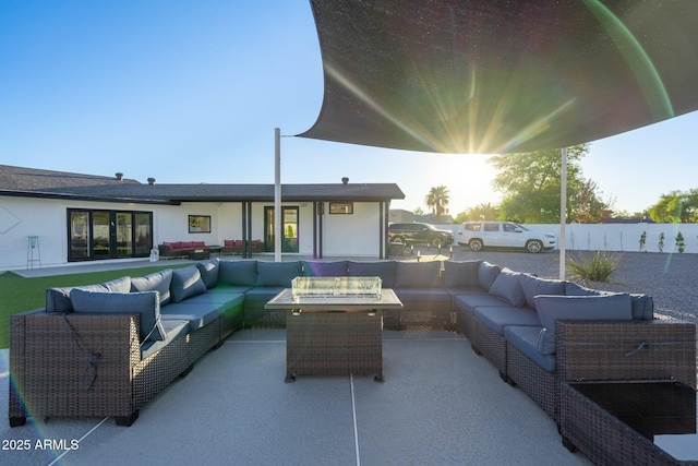 patio terrace at dusk featuring an outdoor living space with a fire pit