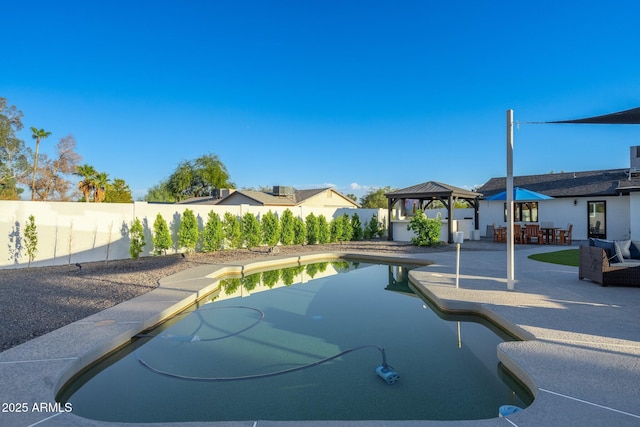 view of swimming pool with a gazebo, a fenced backyard, a patio area, and a fenced in pool