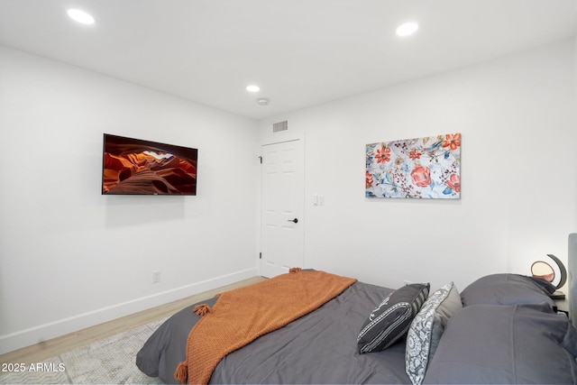 bedroom with visible vents, recessed lighting, and wood finished floors
