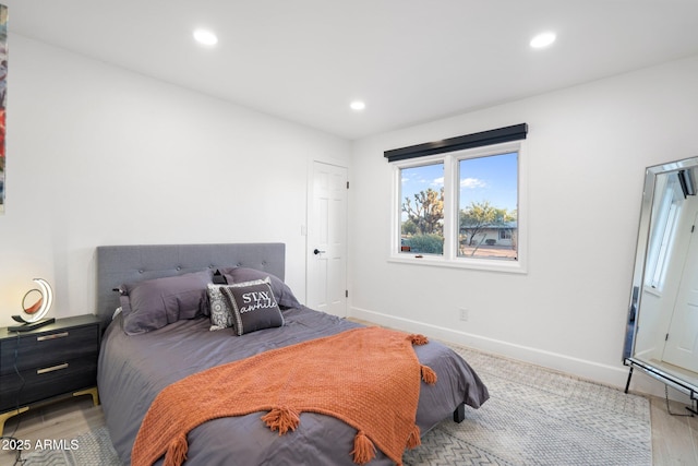 bedroom featuring baseboards, recessed lighting, and light wood-type flooring