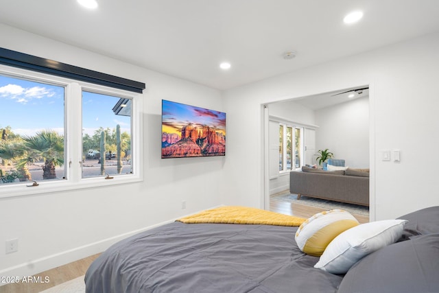 bedroom with recessed lighting, baseboards, and light wood finished floors